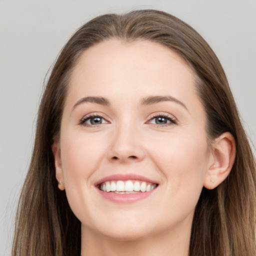 Joyful white young-adult female with long  brown hair and grey eyes