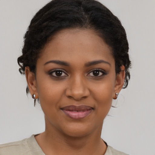 Joyful black young-adult female with short  brown hair and brown eyes