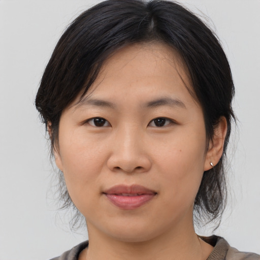 Joyful asian young-adult female with medium  brown hair and brown eyes