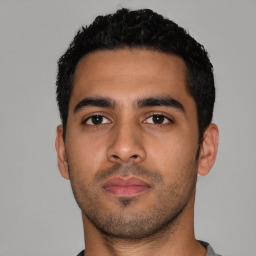 Neutral latino young-adult male with short  black hair and brown eyes