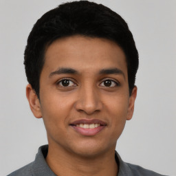 Joyful latino young-adult male with short  black hair and brown eyes