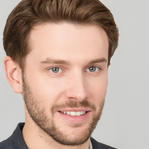 Joyful white young-adult male with short  brown hair and grey eyes