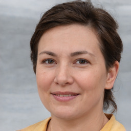 Joyful white adult female with medium  brown hair and brown eyes