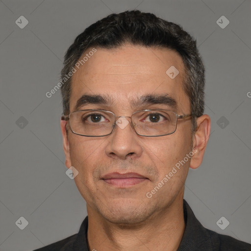 Joyful white adult male with short  black hair and brown eyes