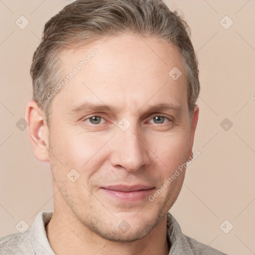 Joyful white adult male with short  brown hair and grey eyes