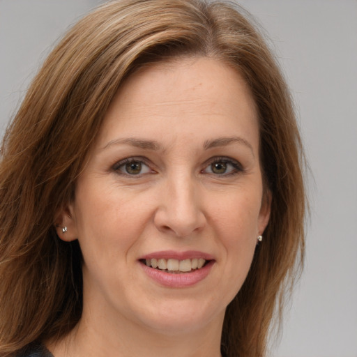 Joyful white adult female with long  brown hair and brown eyes