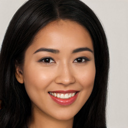 Joyful latino young-adult female with long  brown hair and brown eyes