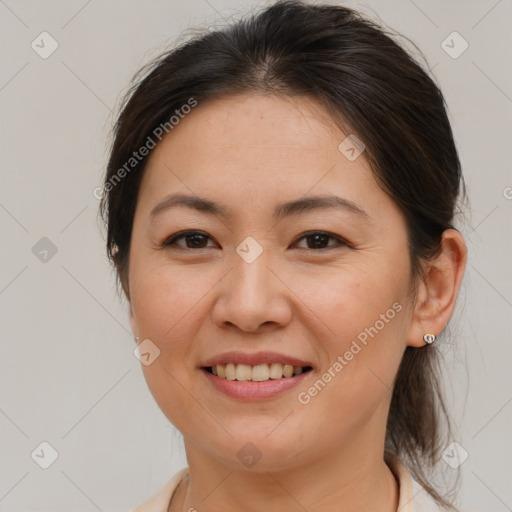 Joyful white adult female with medium  brown hair and brown eyes