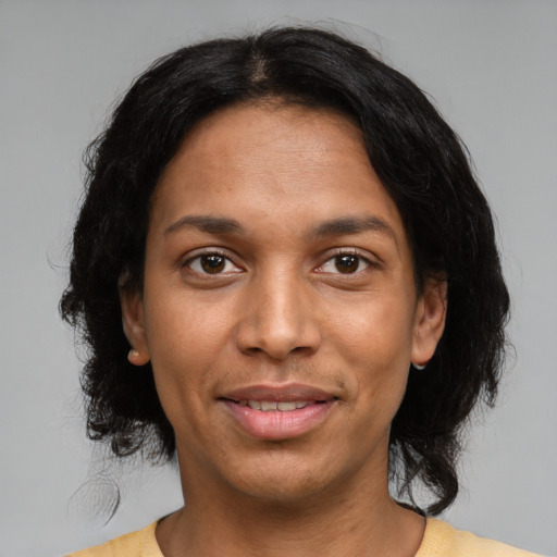 Joyful latino young-adult female with medium  black hair and brown eyes