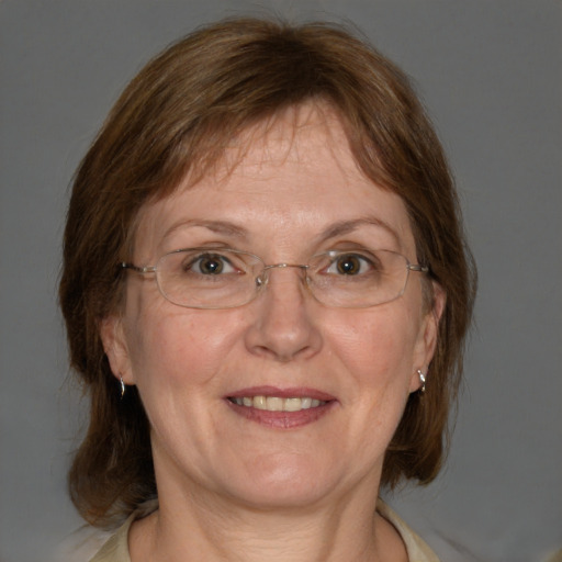 Joyful white adult female with medium  brown hair and blue eyes