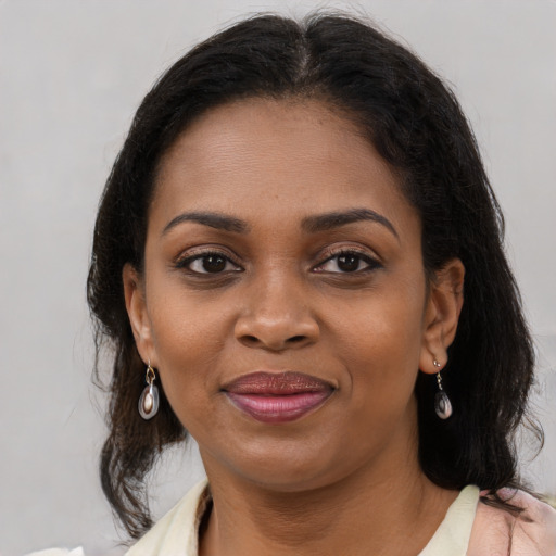 Joyful black young-adult female with medium  brown hair and brown eyes