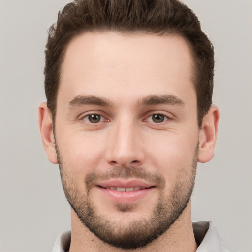 Joyful white young-adult male with short  brown hair and brown eyes