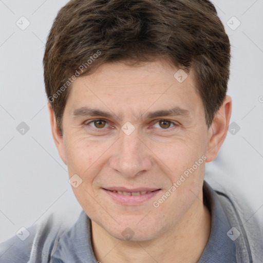 Joyful white adult male with short  brown hair and brown eyes