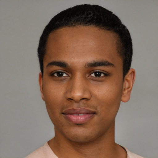 Joyful black young-adult male with short  black hair and brown eyes