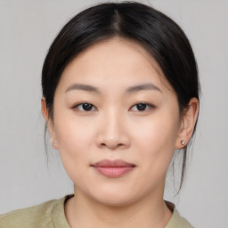 Joyful asian young-adult female with medium  black hair and brown eyes