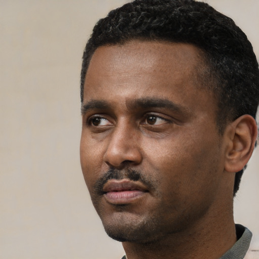 Neutral black young-adult male with short  black hair and brown eyes