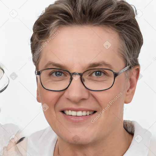 Joyful white adult female with short  brown hair and blue eyes