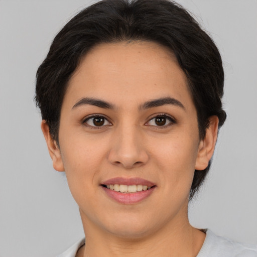 Joyful asian young-adult female with short  brown hair and brown eyes