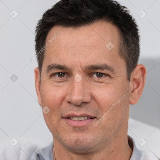 Joyful white adult male with short  brown hair and brown eyes