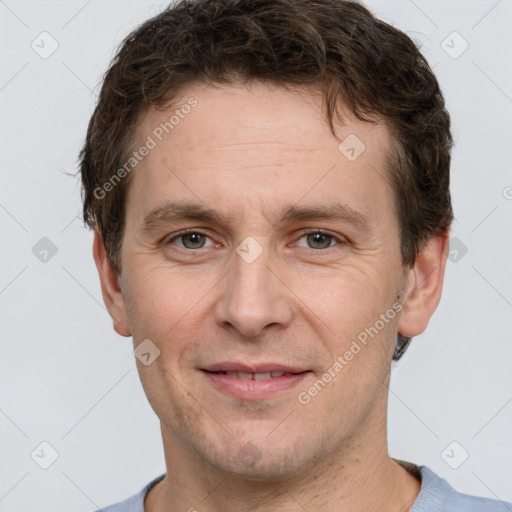 Joyful white adult male with short  brown hair and grey eyes