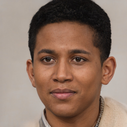 Joyful black young-adult male with short  black hair and brown eyes