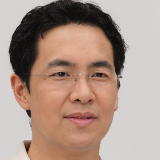 Joyful asian adult male with short  brown hair and brown eyes