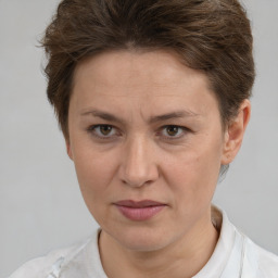 Joyful white adult female with short  brown hair and brown eyes