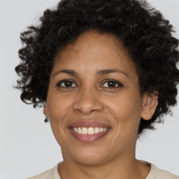 Joyful black adult female with short  brown hair and brown eyes