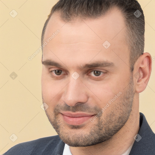 Joyful white adult male with short  brown hair and brown eyes