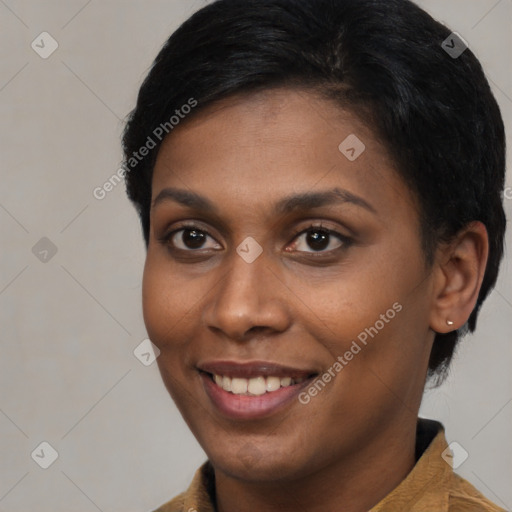 Joyful black young-adult female with short  brown hair and brown eyes