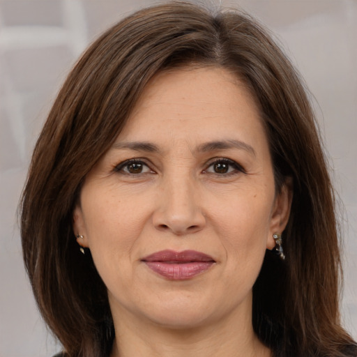 Joyful white adult female with medium  brown hair and brown eyes