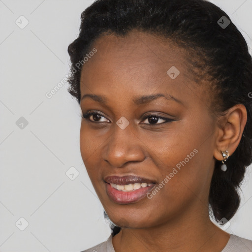 Joyful black young-adult female with short  black hair and brown eyes