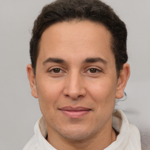 Joyful white adult male with short  brown hair and brown eyes