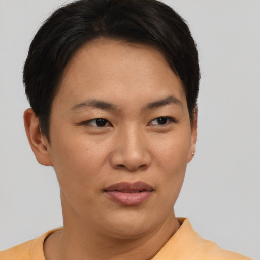 Joyful asian young-adult female with short  brown hair and brown eyes