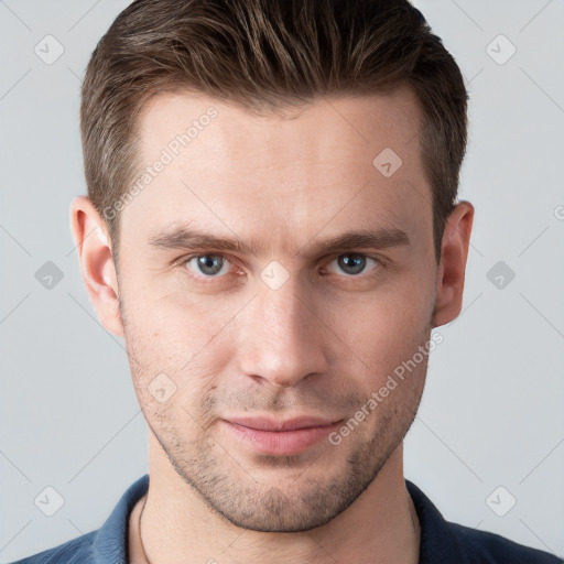 Joyful white young-adult male with short  brown hair and grey eyes