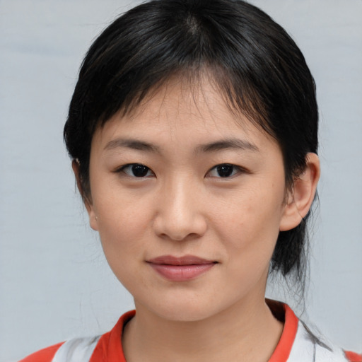 Joyful asian young-adult female with medium  brown hair and brown eyes