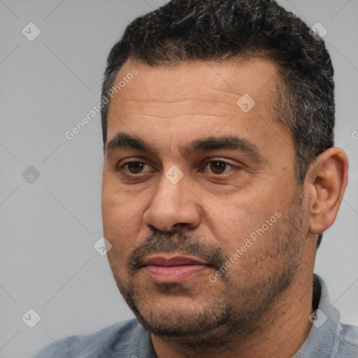 Joyful white adult male with short  black hair and brown eyes