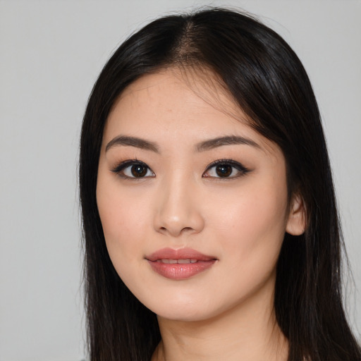 Joyful white young-adult female with long  black hair and brown eyes