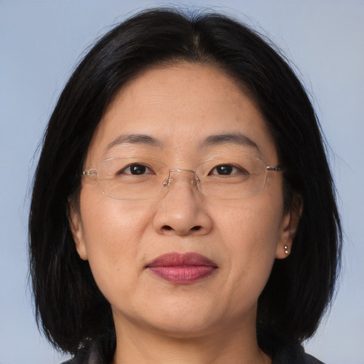 Joyful asian adult female with medium  brown hair and brown eyes