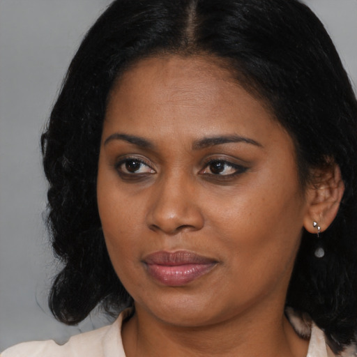 Joyful black young-adult female with medium  brown hair and brown eyes