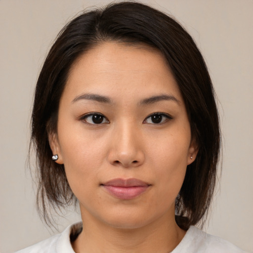 Neutral asian young-adult female with medium  brown hair and brown eyes