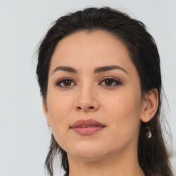 Joyful latino young-adult female with medium  brown hair and brown eyes