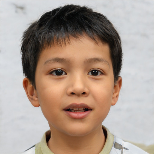 Joyful asian child male with short  brown hair and brown eyes
