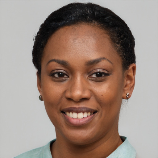 Joyful latino young-adult female with short  black hair and brown eyes
