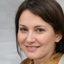 Joyful white adult female with medium  brown hair and brown eyes