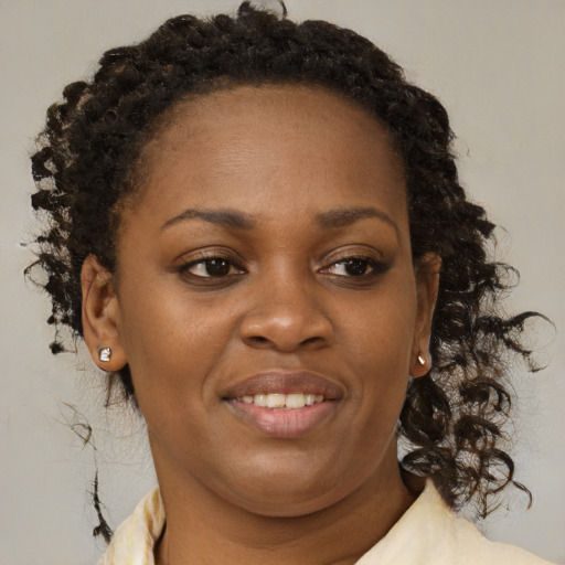 Joyful black young-adult female with medium  brown hair and brown eyes