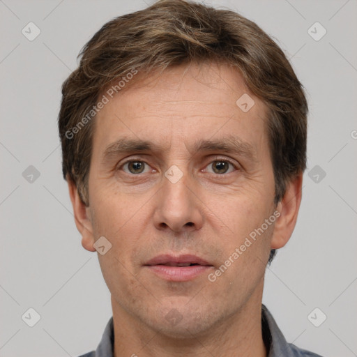 Joyful white adult male with short  brown hair and grey eyes