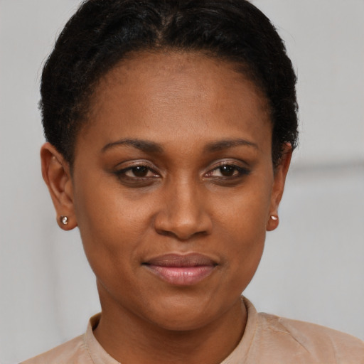 Joyful black young-adult female with short  brown hair and brown eyes
