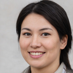 Joyful asian young-adult female with medium  brown hair and brown eyes