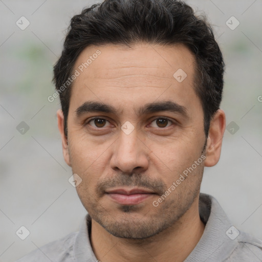 Joyful white adult male with short  black hair and brown eyes